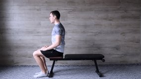 Dragon glag hold on bench. Abs workout videos on a simple wooden background. Hard core bodyweight exercises. How to perform dragon flag hold.