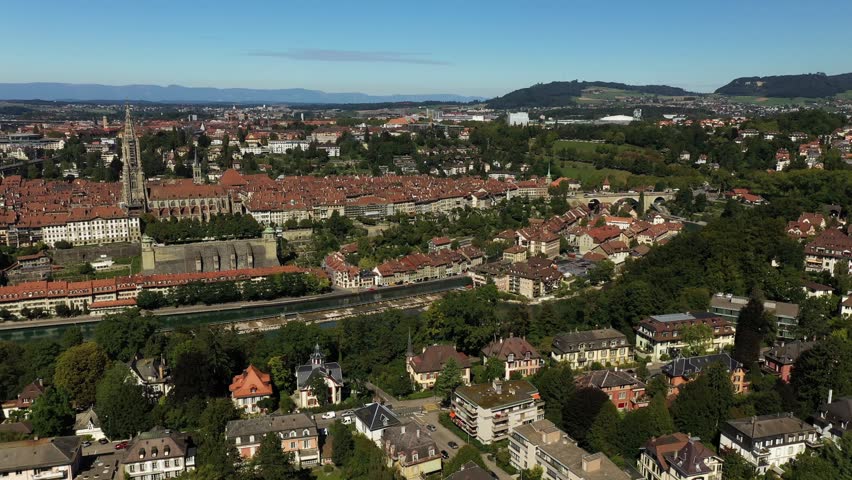 Aerial view of Swiss city with red orange rooftops overlooking river