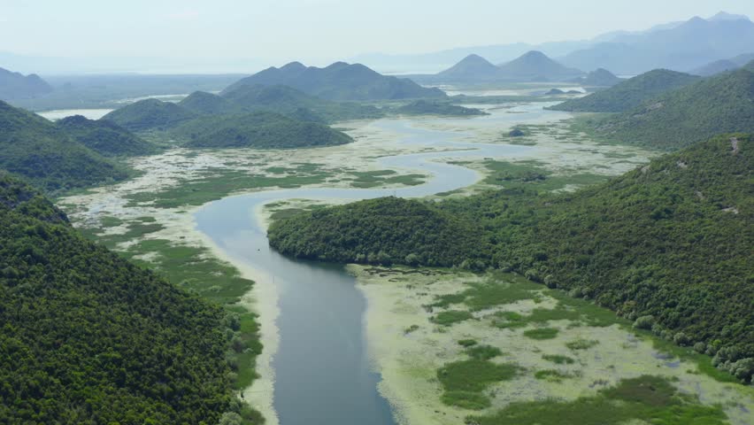 Montenegrin destination - Lake skadar near pavlova strana viewpoint. Aerial view in summer sunny day. Meander of the river in the valley.
