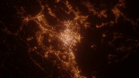 Hiroshima (Japan) aerial view at night. Top view on modern city with street lights. Camera is zooming out, rotating clockwise. Vertical video. The north is on the left side