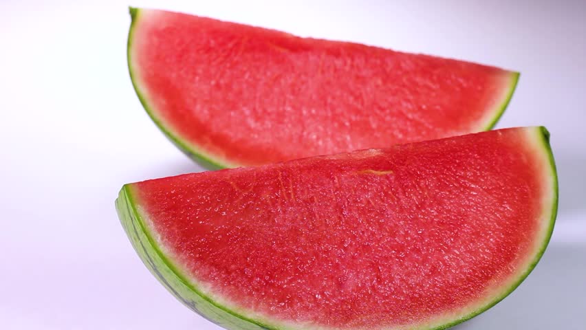 Cross section of seedless watermelon on white background rotating