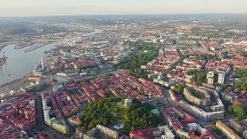 Inscription on video. Gothenburg, Sweden. Panorama of the city and the river Goeta Elv. The historical center of the city. Sunset. On the mechanical display, Aerial View, Departure of the camera