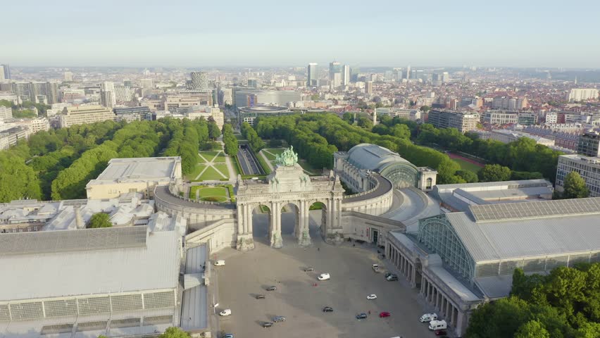 Inscription on video. Brussels, Belgium. Park of the Fiftieth Anniversary. Park Senkantoner. The Arc de Triomphe of Brussels (Brussels Gate). Arises from blue water, Aerial View
