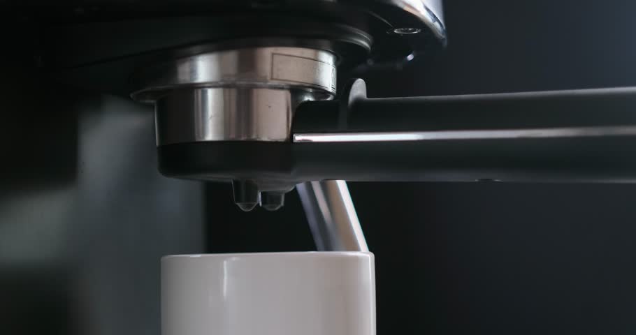 Home Espresso making process - coffee stream pouring from machine into ceramic cup | Shutterstock HD Video #1100903743