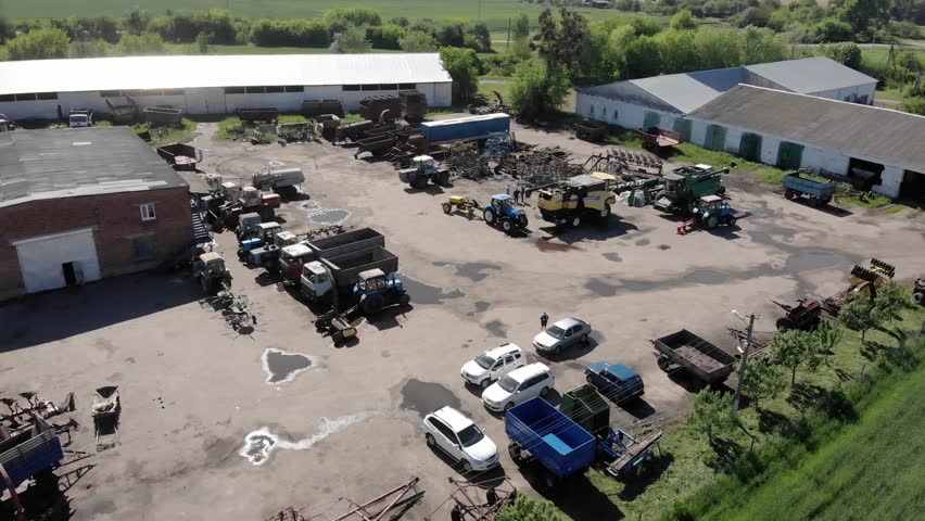 Aerial view of farm machinery stock at the small farm in ukrainian village | Shutterstock HD Video #1100903911
