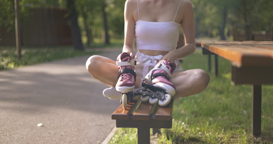 Young girl sitting with her legs crossed on a park bench