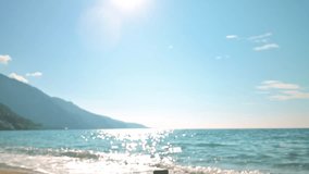 Beautiful sea waves and stone pyramid on a sand beach. 4k slow motion footage UHD 3840x2160 