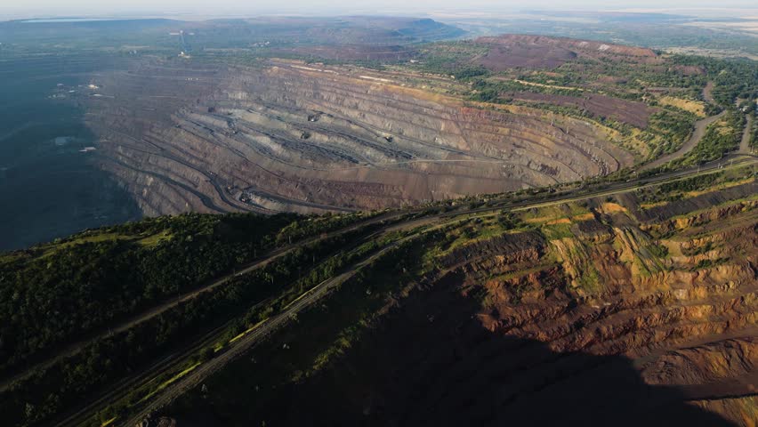 Panorama aerial view shot open pit mine coal mining, dumpers, quarrying extractive industry stripping work. Big Yellow Mining Trucks. View from drone at opencast mining with lots of machinery trucks Royalty-Free Stock Footage #1100909777