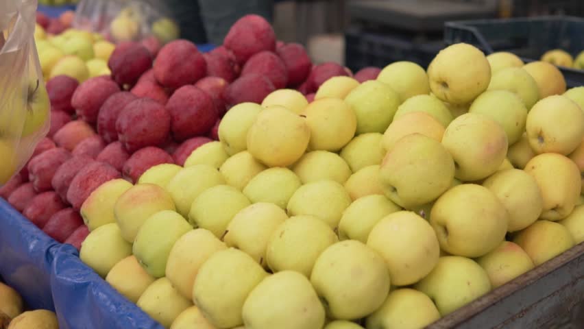 Buyer chooses apples at the farmer's market, Turkey, Alanya, close-up.