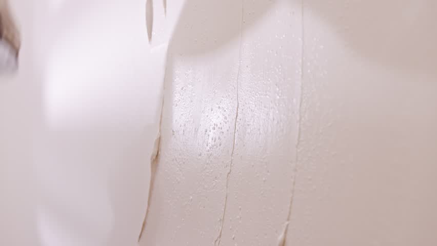 Close up of construction worker applying plaster to a wall during renovation project | Shutterstock HD Video #1100914035