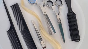 Set of hairdresser tools and hair. Shiny steel scissors and comb ready to use concept