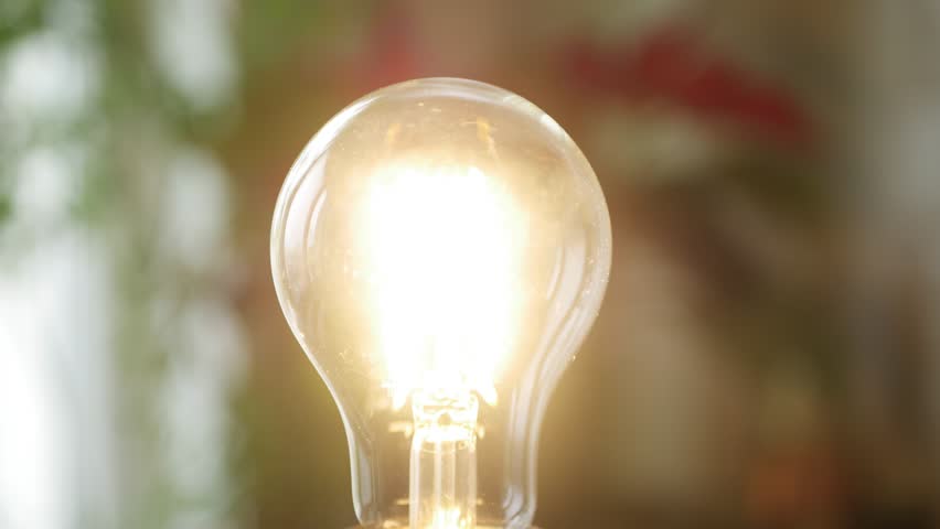 Turn Off the Light in Room, Saving Concept Using Led Bulb in Energy Industry Crisis, Girl Screws a Led Light Bulb in Socket Royalty-Free Stock Footage #1100916733