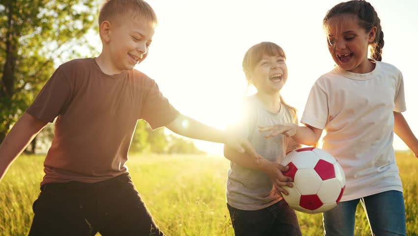 Children in the park. play ball, run and team up. happy family a kid dream concept. children run, play ball and learn to teamwork. children run, play ball and lifestyle spend time in the park | Shutterstock HD Video #1100917723