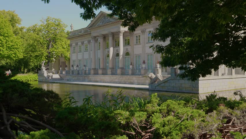 Summer day view of the Palace on the Isle (Polish: Pałac Na Wyspie), also known as Baths Palace (Polish: Pałac Łazienkowski) Łazienki Park or Royal Baths Park. Landmark of Poland.