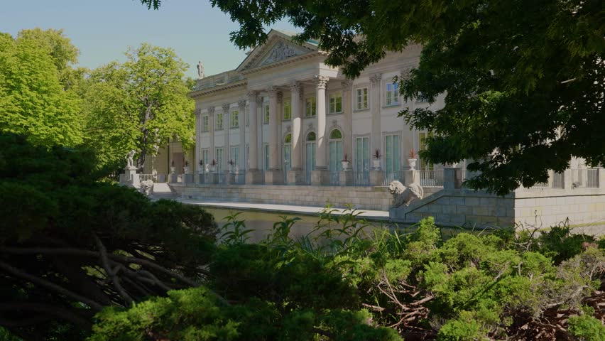 Summer day view of the Palace on the Isle (Polish: Pałac Na Wyspie), also known as Baths Palace (Polish: Pałac Łazienkowski) Łazienki Park or Royal Baths Park. Landmark of Poland.