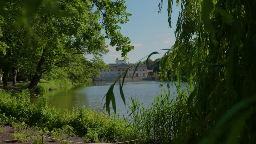 Summer day view of the Palace on the Isle (Polish: Pałac Na Wyspie), also known as Baths Palace (Polish: Pałac Łazienkowski) Łazienki Park or Royal Baths Park. Landmark of Poland.