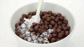 Pouring milk in bowl with Chocolate breakfast cereal, close up - Powered by Shutterstock - Get 15% off with code: PIKWIZARD15