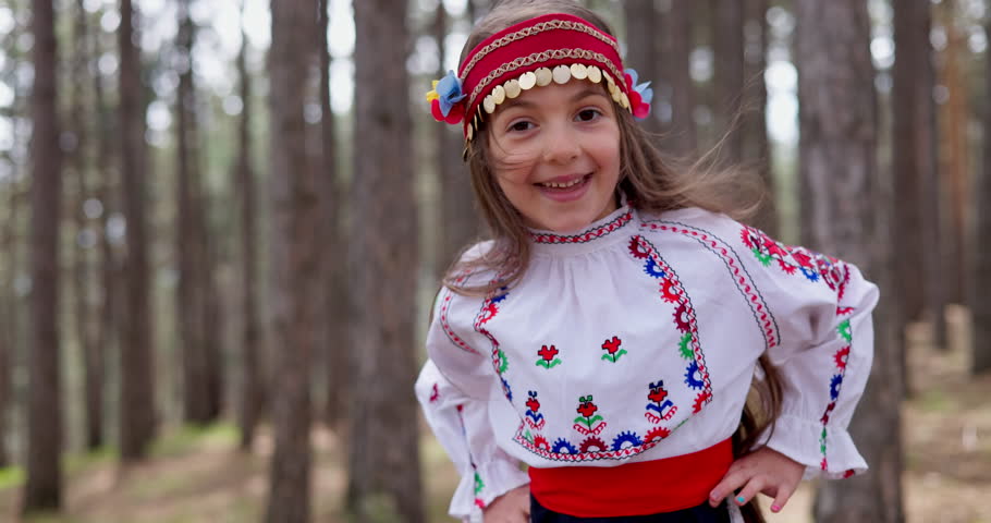 Girl in traditional ethnic costume dance bulgarian folklore horo, rachenitsa in a mountain forest. Bulgaria, heritage and culture, 4k slow motion video