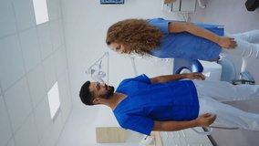 Video of young dentists at private dental clinic. Vertical footage.