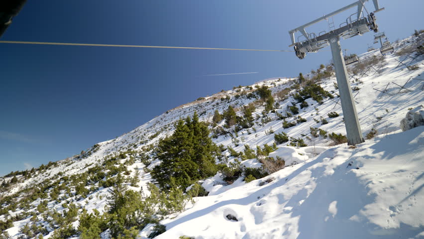 Skiing and snowboarding in the Italian Alps. Beautiful winter view from gondola on the Monte Bondone mountain of Trentino, northern Italy.