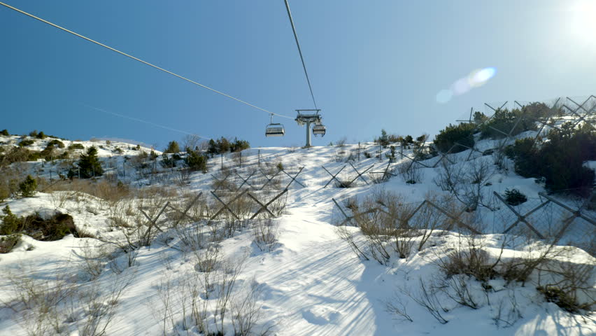 Skiing and snowboarding in the Italian Alps. Beautiful winter view from gondola on the Monte Bondone mountain of Trentino, northern Italy.
