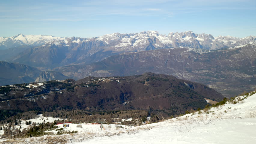 Skiing and snowboarding in the Italian Alps. Beautiful winter view on the Brenta group from the Monte Bondone mountain of Trentino, northern Italy