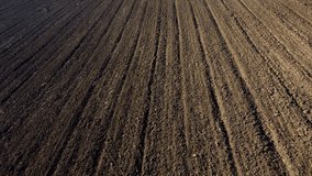 Landscape of plowed up land on an agricultural field on a sunny autumn day. Flying over the plowed earth with black soil. Black soil. Ground earth dirt priming aerial drone view. Agrarian background - Powered by Shutterstock - Get 15% off with code: PIKWIZARD15