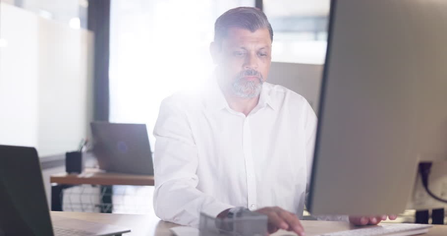 Office, computer and business man typing email, report or working on project. Online planning, marketing research and mature male employee on pc writing sales proposal in the morning in workplace.
