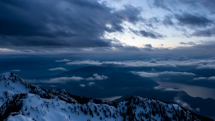Aerial view of a Canadian Landscape during a winter sunset. Taken in Howe Sound, North of Vancouver, British Columbia, Canada. Cinemagraph Continuous Loop Animation Royalty-Free Stock Footage #1100930681