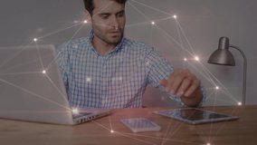 Glowing network of connections against caucasian man using laptop and digital tablet. global networking and business technology concept - Powered by Shutterstock - Get 15% off with code: PIKWIZARD15
