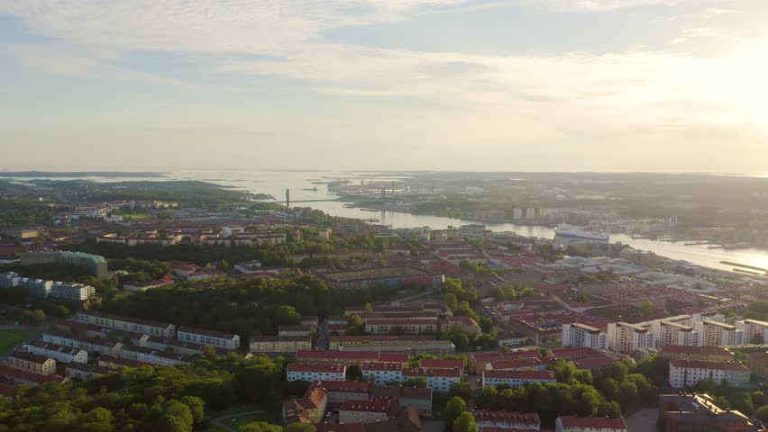 Inscription on video. Gothenburg, Sweden. Panorama of the city and the river Goeta Elv with ships. Sunset. Lightning strikes the letters, Aerial View