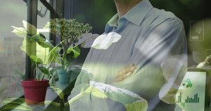 Animation of plants over caucasian businessman in office. Global business, finances, computing and data processing concept digitally generated video.