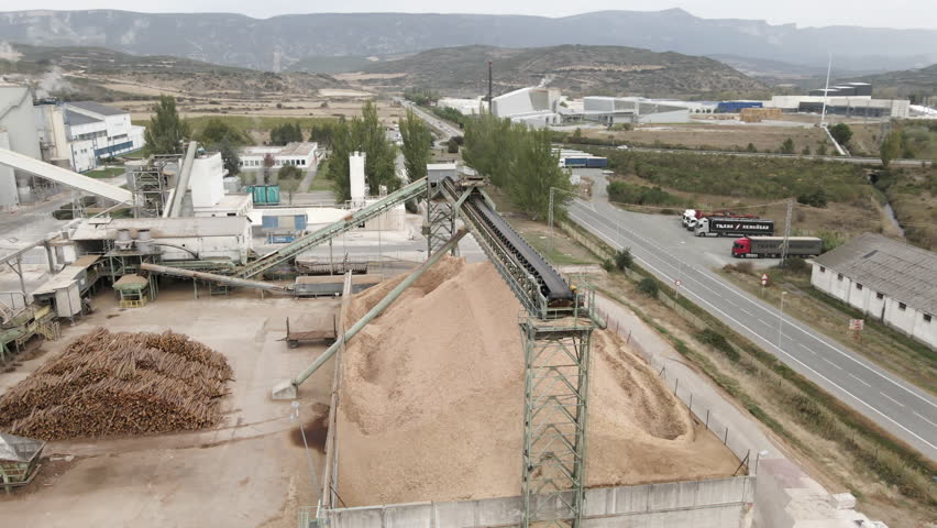 Wood being processed at a factory for furniture material. Aerial view of active sawmill 