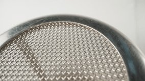 I twist in my hand a metal mesh for tea brewing. Macro - Powered by Shutterstock - Get 15% off with code: PIKWIZARD15