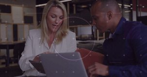 Animation of financial data processing over diverse business people in office. Global business, finances, computing and data processing concept digitally generated video.