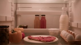 View inside from refrigerator Indian sly man with curly hair open fridge at night evening in kitchen hungry guy male looking around take out slice of pizza overeating at nighttime unhealthy nutrition - Powered by Shutterstock - Get 15% off with code: PIKWIZARD15