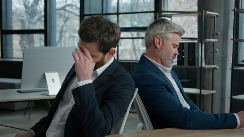 Upset shocked caucasian men businessmen partners employees sitting in office frustrated with business failure think about financial problem depressed entrepreneurs colleagues have trouble feel worried Royalty-Free Stock Footage #1100943585