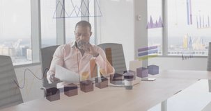 Animation of financial data processing over african american businessman in office. Global business, finances, computing and data processing concept digitally generated video.