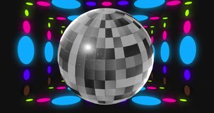 Animation of disco ball over colorful spots on black background. Party and celebration concept digitally generated video.
