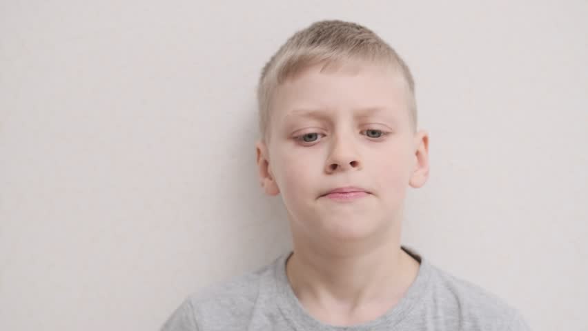 sad boy close up. Young sad cute boy. Unhappy alone young kid. Close up frustrated teenager face. domestic abuse, family violence. stop bullying kids concept Royalty-Free Stock Footage #1100947203