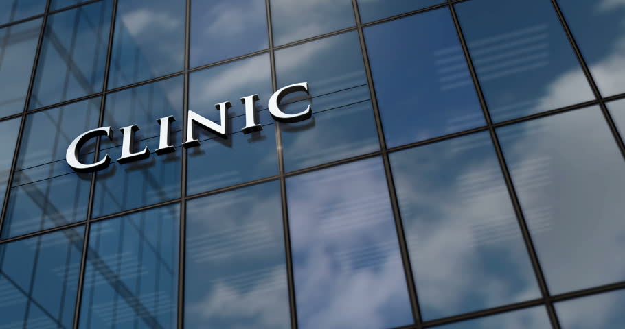 Clinic glass building concept. Medicine care and medical health center symbol on front facade 3d. | Shutterstock HD Video #1100949755