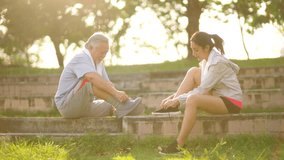 Happy Asian family senior man and adult child do sport training workout exercise together at park. Father and daughter tie shoelaces while running in city. Elderly people wellness healthcare concept. - Powered by Shutterstock - Get 15% off with code: PIKWIZARD15
