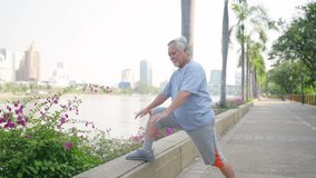 4K Elderly Asian man in sportswear warm up exercise before jogging workout at park in summer morning. Healthy retired person enjoy outdoor lifestyle fitness sport training running exercise in the city - Powered by Shutterstock - Get 15% off with code: PIKWIZARD15