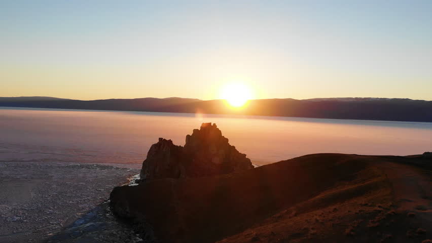 Sunset over Lake Baikal in spring. Shamanka Rock or Cape Burkhan 
