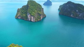 Stunning islands, sandy beaches, lush forests, limestone mountains, and long tail boats offer an unforgettable tropical travel experience for tourists. Lao la ding island, Krabi Province, Thailand
