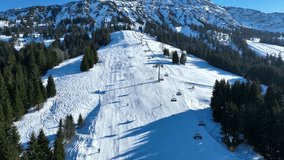 Video with a drone from a ski lift with skiers in Oberallgäu