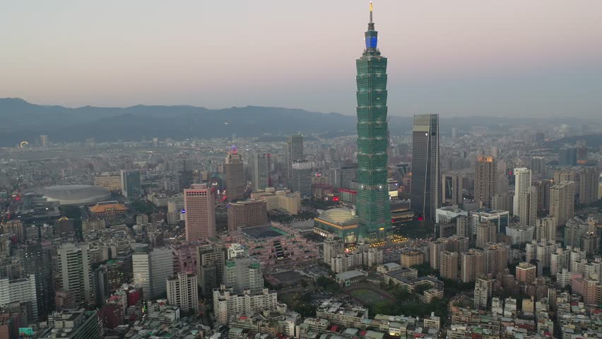 Aerial skyline at sunrise over Taipei, the vibrant capital city of Taiwan, with 101 Tower standing among high rise skyscrapers in Xinyi District and oval shaped Taipei Dome located in the nearby area