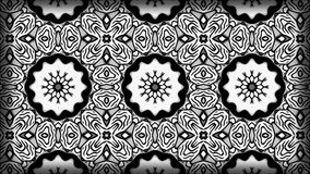 Kaleidoscope sequence with mandala patterns. Motion. Rows of changing shaped and flowers.