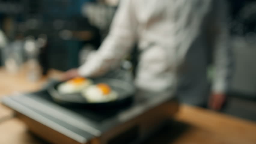 Professional kitchen: scrambled eggs are fried in pan | Shutterstock HD Video #1100960267