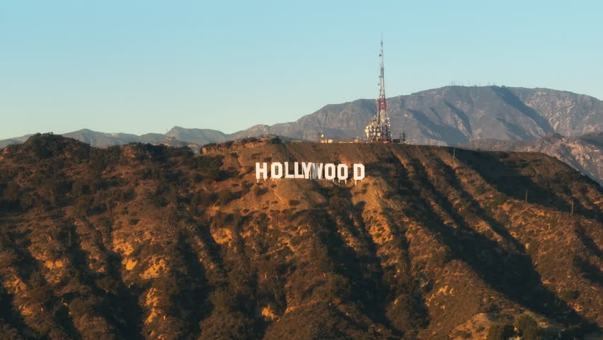 Hollywood Sign, Los Angeles USA Feb. 2023. Sunset Aerial Rotating around Hollywood sign white letters. Cinematic Los Angeles landmark historic Hollywood cinematography. Hollywood entertainment capital